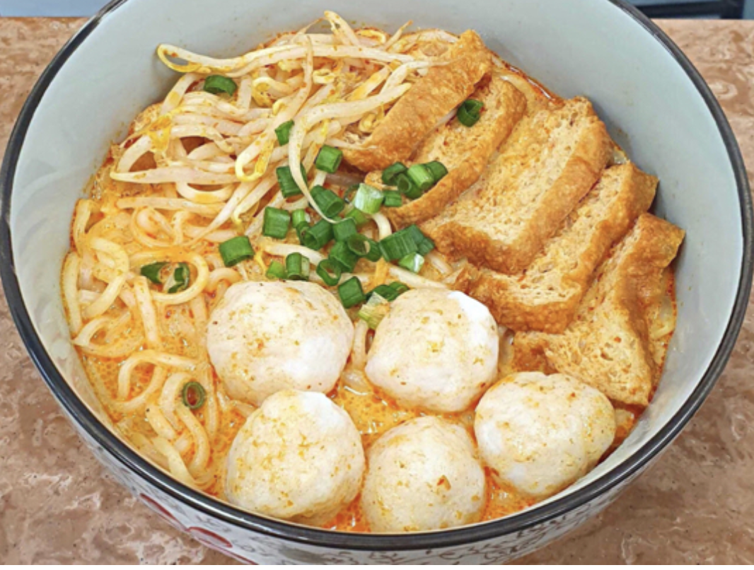 bowl of noodles, dumplings, and alternative meat